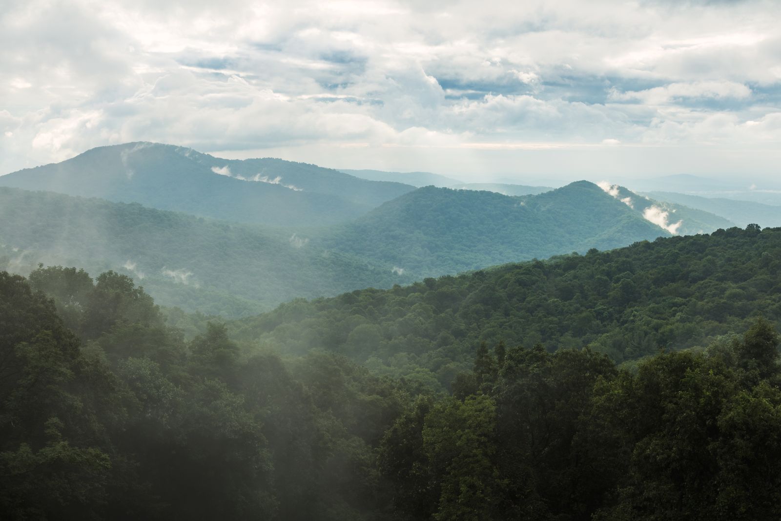 Layered Blue Ridge ridgelines under a bright sky