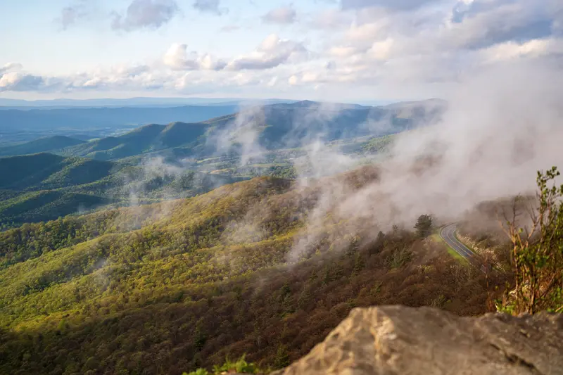 Mist rising along a forested ridge
