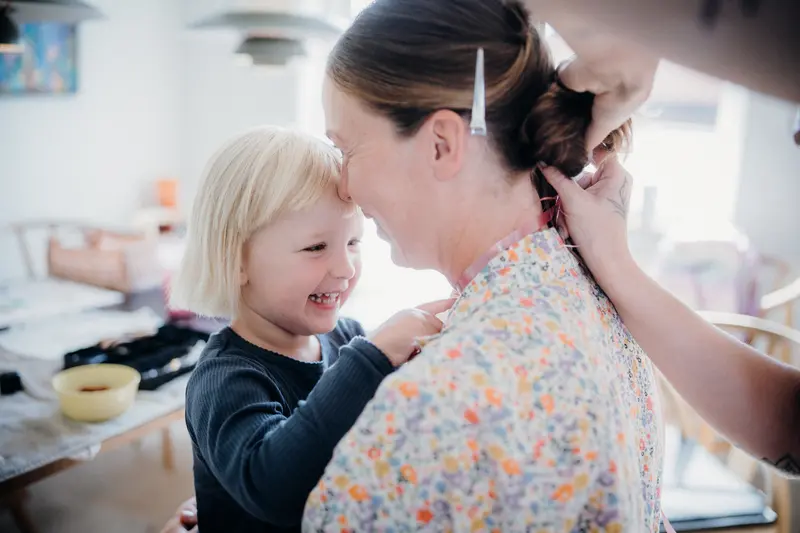 A mother and daughter share a joyful embrace at home, exuding warmth and togetherness.