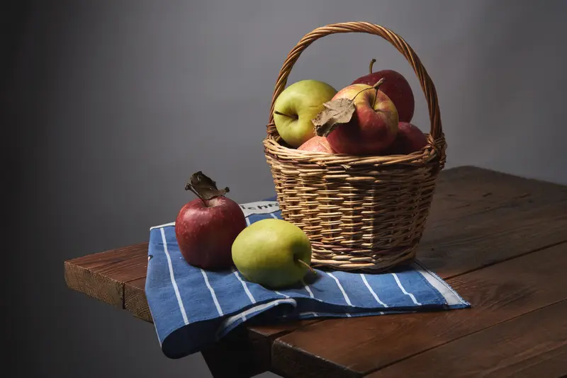 A basket of apples on a wooden table