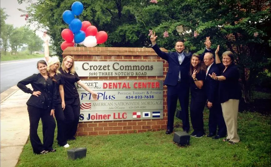 The team celebrating at the Crozet Commons sign