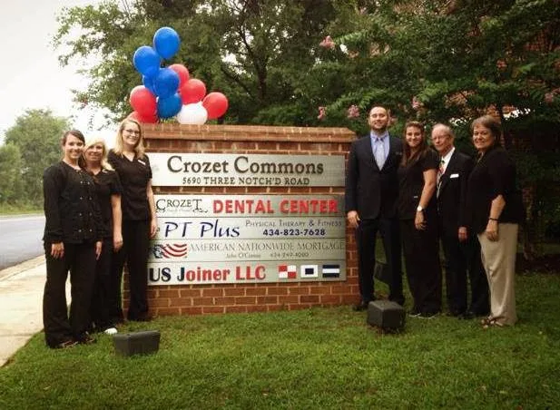 Team members at the Crozet Commons sign